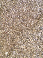 shoreline with small pebbles and water close-up. High quality photo