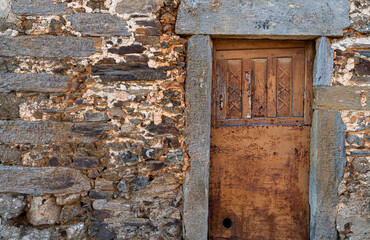 Old run-down wooden door with slate jamb
