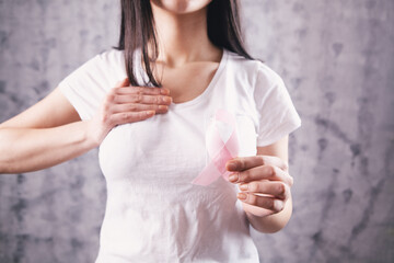 female hands holding a pink ribbon