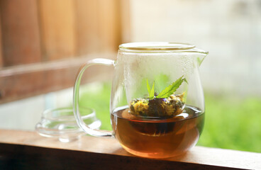 flowers tea in glass jar with cannabis leaf for healthy aroma drinking