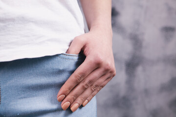 young woman puts her hand in her pocket