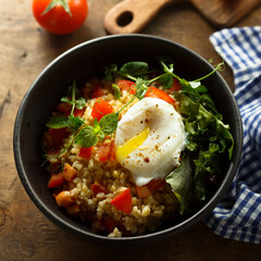 Bulgur with tomato and poached egg