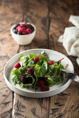 Obraz na płótnie Canvas Healthy green salad with raspberry