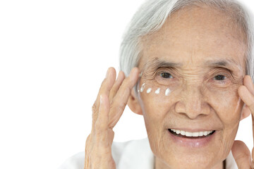 Obraz premium Close-up,Face of asian senior woman applying eye cream,anti-aging,nourishing under eye,facial treatment,happy smiling old elderly removing wrinkles crow's feet surrounding their eyes,skin care concept