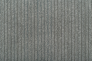 Grey flossy towel texture close up. Fluffy cozy bathrobe fabric with vertical stripes. Textured textile background with space for text