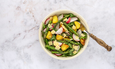 Grilled green asparagus salad with fresh radish, arugula, potatoes, and parmesan cheese.
