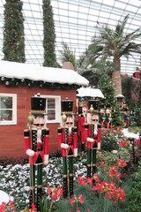 Christmas decorations inside greenhouse. Nutcrackers standing in front of houses