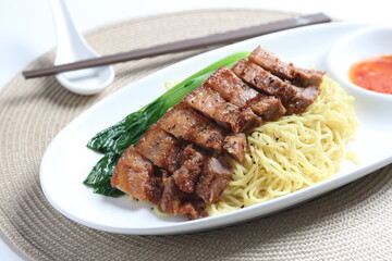 chef cook dry noodle mee with grilled chicken chop, pork cutlet and vegetable in soy sauce and...