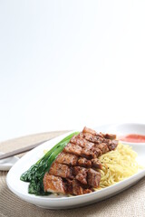 chef cook dry noodle mee with grilled chicken chop, pork cutlet and vegetable in soy sauce and chilli sauce asian halal menu