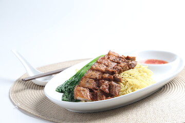 chef cook dry noodle mee with grilled chicken chop, pork cutlet and vegetable in soy sauce and chilli sauce asian halal menu