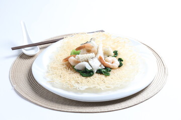 deep fried crispy bee hoon noodle with mixed seafood fish, prawn, squid, octopus and vegetables in thick egg gravy sauce asian halal menu