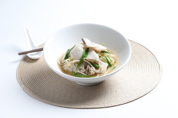 hot wok fried kway teow noodle with grouper fish slices and vegetables in thick gravy egg sauce in bowl asian halal menu