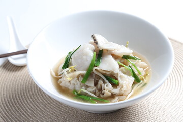hot wok fried kway teow noodle with grouper fish slices and vegetables in thick gravy egg sauce in bowl asian halal menu