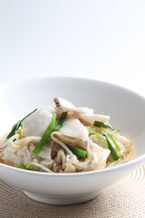 hot wok fried kway teow noodle with grouper fish slices and vegetables in thick gravy egg sauce in bowl asian halal menu