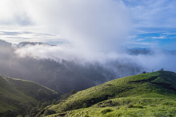 Angle view of a beautiful rural landscape with green pastures and mountains full of tropical...
