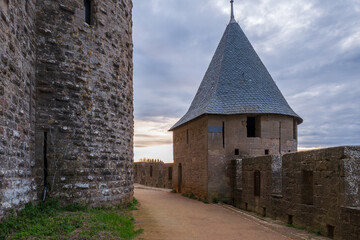 Fototapeta premium Sunset on the rampart and the tower named tour du Grand Camisou in the Cité de Carcassonne, the medieval fcity of Carcassonne, Department of the Aude, Occitanie region, France. UNESCO World heritage