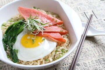 chef cook noodle mee soup with chicken ham and fried egg and vegetable asian halal menu