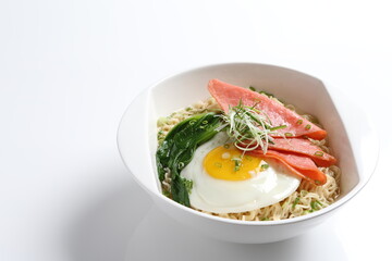 chef cook noodle mee soup with chicken ham and fried egg and vegetable asian halal menu