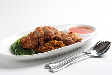 chef cook dry noodle mee with grilled chicken chop, pork cutlet and vegetable in soy sauce and chilli sauce asian halal menu