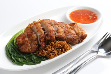 chef cook dry noodle mee with grilled chicken chop, pork cutlet and vegetable in soy sauce and chilli sauce asian halal menu