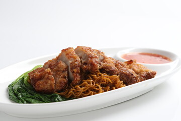 chef cook dry noodle mee with grilled chicken chop, pork cutlet and vegetable in soy sauce and...