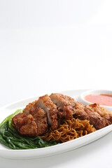 chef cook dry noodle mee with grilled chicken chop, pork cutlet and vegetable in soy sauce and chilli sauce asian halal menu