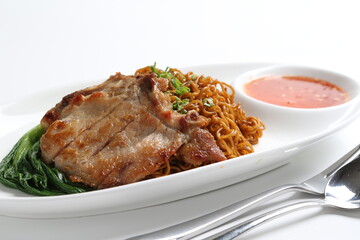 chef cook dry noodle mee with grilled chicken chop, pork cutlet and vegetable in soy sauce and chilli sauce asian halal menu