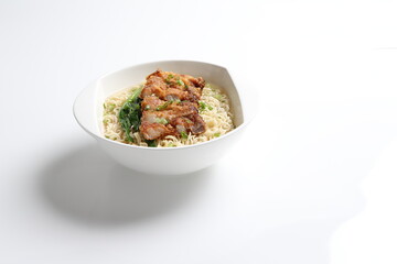 chef cook noodle mee soup with grilled chicken chop, pork cutlet and vegetable asian halal menu