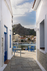 Fototapeta na wymiar The old port and the castle of Myrina on the island of Lemnos between a cobbled path