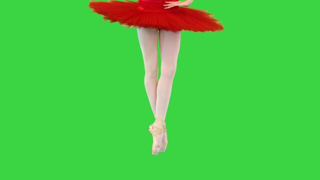 Young ballerina in red classical tutu walks en pointe (waist and legs) on a Green Screen, Chroma Key.