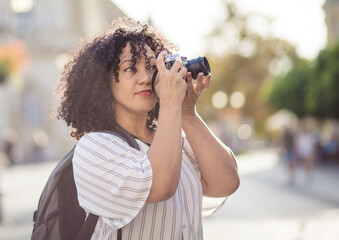 Mixed race woman taking photo.