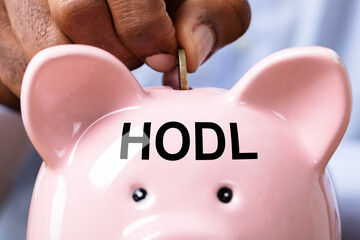Man Inserting Coin In Piggybank