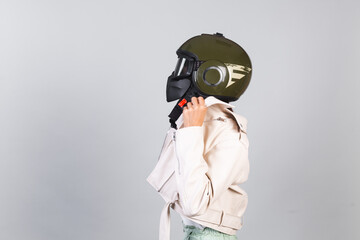 Woman in leather jacket and helmet on gray background