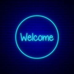 Neon welcome sign in a circle on blue brick wall background