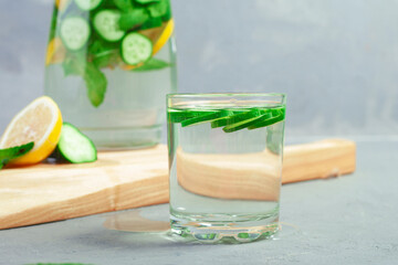 Fresh cool detox water drink with cucumber and lemon. glass of Lemonade with basil and mint leaves. Concept of proper nutrition and healthy eating. Fitness diet. Copy space for tex