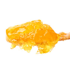 naturally crystallized rape honey on white wooden