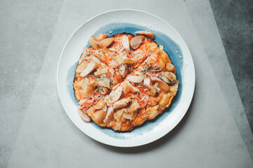 Tasty hot homemade pizza with hotdog and crab sticks with cheese.