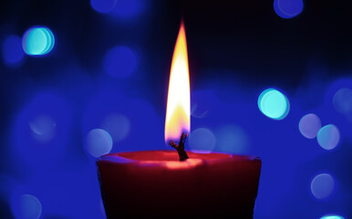 Candle lights in darkness with colorful light effects and bokeh for solemn moments and wallpaper. Candle flame light at night with the background.