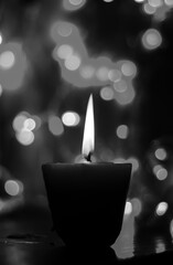 Candle lights in darkness with colorful light effects and bokeh for solemn moments and wallpaper. Candle flame light at night with the background.