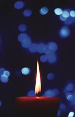 Candle lights in darkness with colorful light effects and bokeh for solemn moments and wallpaper....