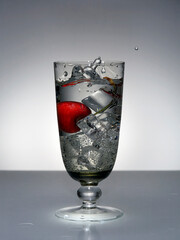 Cocktail with gin-tonic and its splash in glass
