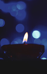 Candle lights in darkness with colorful light effects and bokeh for solemn moments and wallpaper....