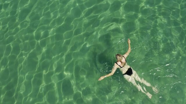 Aerial view of a girl floating in the Adriatic Sea, Croatia