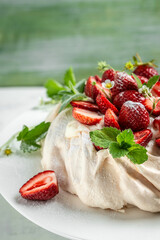 pavlova meringue cake decorated with fresh strawberries and whipped cream. food, culinary, baking and cooking concept