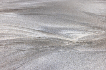 Fototapeta na wymiar 波の作った砂の上の抽象的な模様