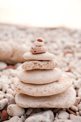 Stack of beach pebble stones at sea shore outdoors. Summer vacation season. Balance and stability...