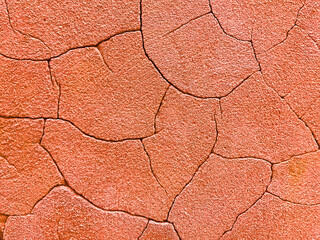 Bright orange concrete background with large cracks
