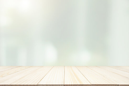 Empty wood table top with blur window curtain background for product display