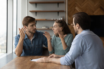 Stressed young family couple arguing, feeling dissatisfied with professional consultation or offer....