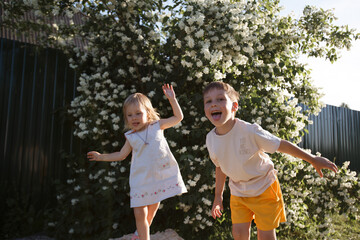 Obraz premium brother and sister play together on the street and make faces